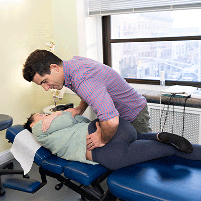 Female Patient receiving a chiropractic adjustment in Hoboken NJ at Hudson Family Chiropractic